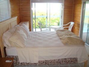 Master bedroom with balcony and private bathroom.