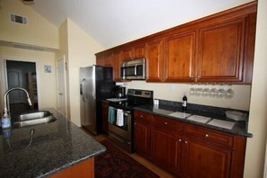 Fully equipped kitchen with stainless steel appliances.