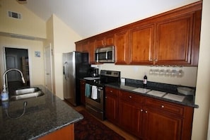 Fully equipped kitchen with stainless steel appliances.