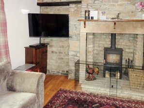 Cosy country living room with beamed ceiling and woodburner | Sycamore Cottage, Grassington