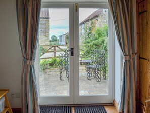 French doors from living area to patio seating area | Dragonfly Cottage - West End Farm Cottages, Brompton by Sawdon