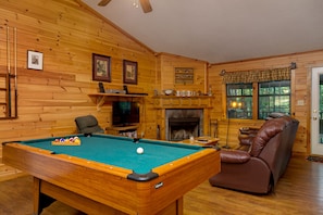 Living Room with Wood Fireplace and Pool Table