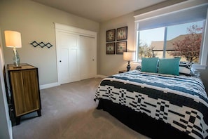 Main floor room with a queen bed and twin trundle underneath