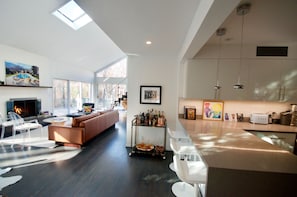 Living room with fireplace and views to back of house