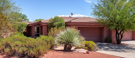 Casa De Paz with great desert landscaping and 2 car garage. 