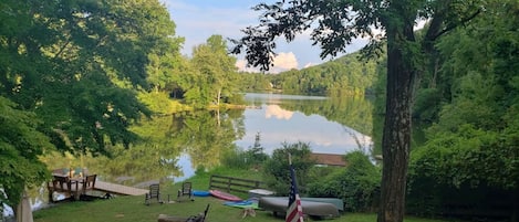 A tranquil lake view from our four-season porch, complete with a cozy fire pit to gather around.