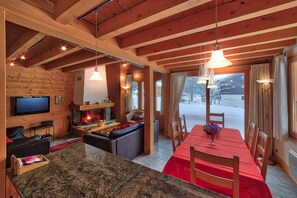 Espace de vie ouvert avec feu de bois ~ Salon / salle à manger et cuisine