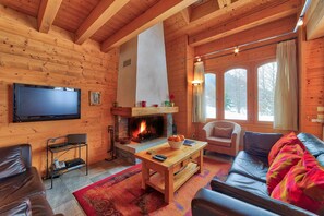 Spacious Living Room with Log Fire TV and various different seating.