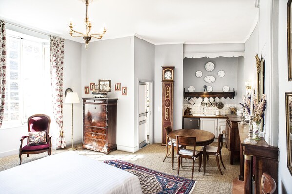 Handsome antique furnishings and modern conveniences like the kitchenette.