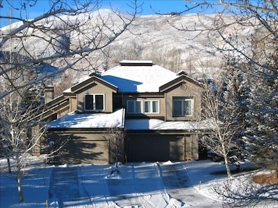 wintertime with plowed driveway and mountain views