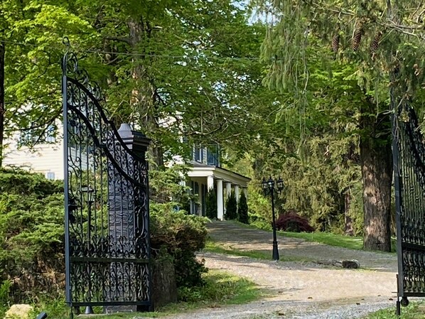Driveway toward the house through iron gates