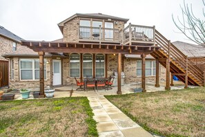 Private backyard with covered patio, grill, and balcony with views.