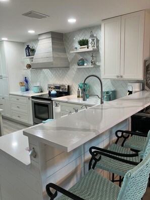 Brand new kitchen w/ spices, plenty of plates, pots, pans and utensils.