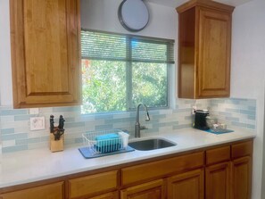 Well equipped kitchen:  Dishes, silverware and a Brita water pitcher.