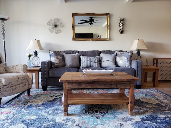 Spacious living room featuring queen sleeper sofa and recliner.