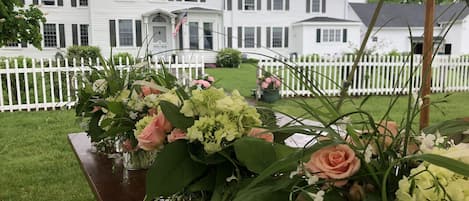 Front of house before family wedding with flower arrangements.