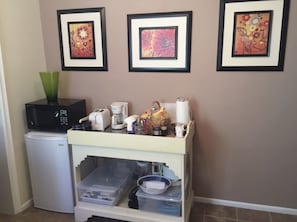 Small fridge and microwave. Coffee maker and kettle.