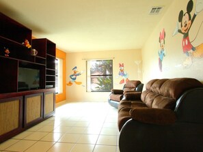 Living Room with Comfortable Seating and Whimsical Art