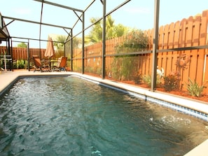 Screened Pool with Table and Four Chairs and Two Sun Loungers