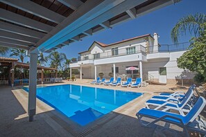 Garden with barbecue, seating area, sun loungers and private pool