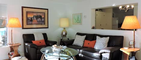 Living Room has Bamboo Floors, Western Art, Lots of Light & Leather Furniture!