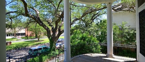 The main porch that is supported by stately columns overlooking the Avenue & oak