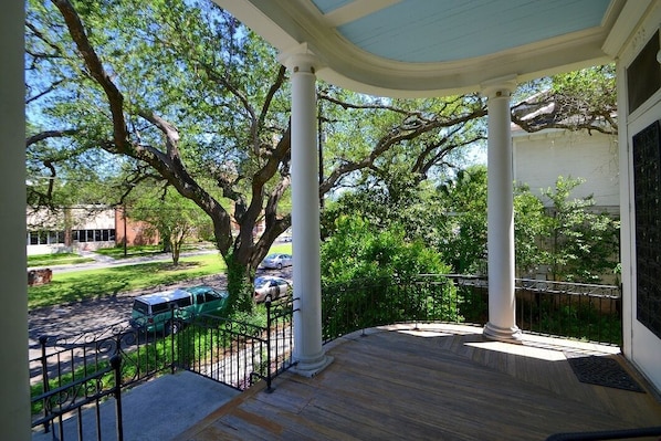 The main porch that is supported by stately columns overlooking the Avenue & oak