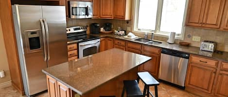 Fully Equipped Kitchen - Newly remodeled, fully equipped kitchen with an open dining room area.