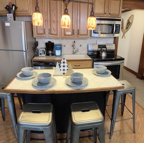 Enjoy your meals at the kitchen island that sits four people.