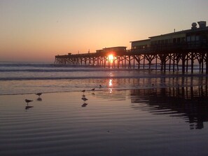 Early morning beach view of the Crabby Joe's Pier directly next to our condo