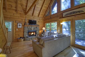 Large vaulted ceilings, comfortable seating and fireplace make this a very cozy space