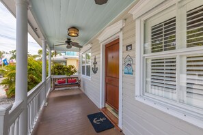 The home's private, covered porch with swing seating for two