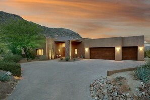 Front entrance with 3 car garage, view of Tortolitas