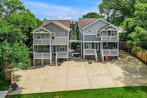 Massive Parking Pad for 6 cars per house - driveway wraps around to exits with auto electronic gates