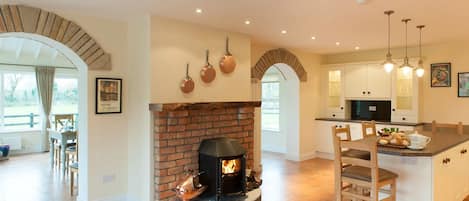 A burning log stove sets the mood in the kitchen!