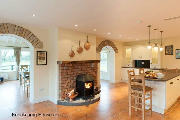 A burning log stove sets the mood in the kitchen!
