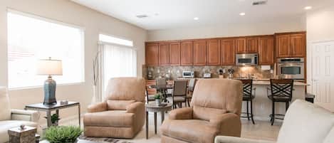 Great Room features 80" Samsung Smart TV with plush leather love seat sofa and two electric supple captains chairs