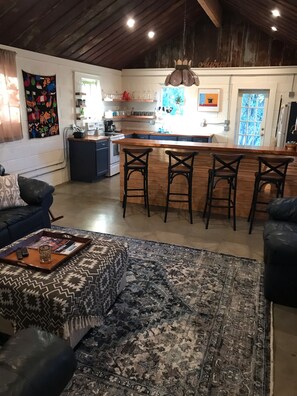 Kitchen warmly opens up to the living room area. Bar seating for four!