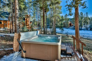 Private hot tub sits 8 is among tall pines. Has amazing view of stars & meadow.