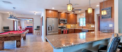 Large fully stocked kitchen with pool table and bar