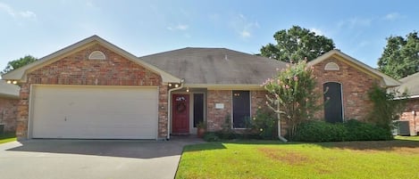 Home exterior with parking for 4 cars in driveway and garage. 