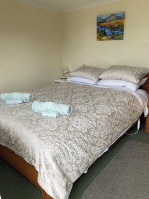 Sleepout bedroom. Queen bed. Has shower and toilet at the back of the bedroom.
