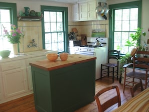 Sunny country kitchen with wide pine floor floorboards