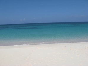 Our beach facing west on a windless day.  Many days there are waves on this beach good for body surfing.