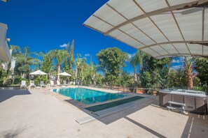 Spacious Garden with barbecue, dining area, sunloungers, pool, and jacuzzi