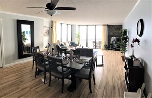 Dining room into living room into the balcony with the view.