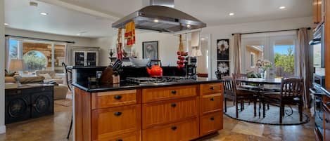 Kitchen & bistro nook w/granite counters, travertine floor & open to living room