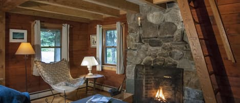 Cozy living space with fieldstone fireplace.