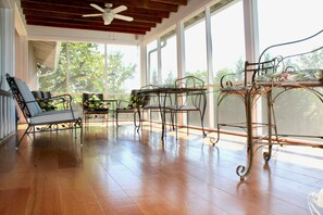 Screened porch overlooks pool and lawn