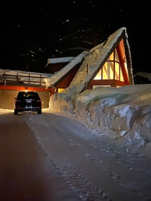 Tahoe cabin exterior - Chalet style. Night view with driveway for 4 vehicles.